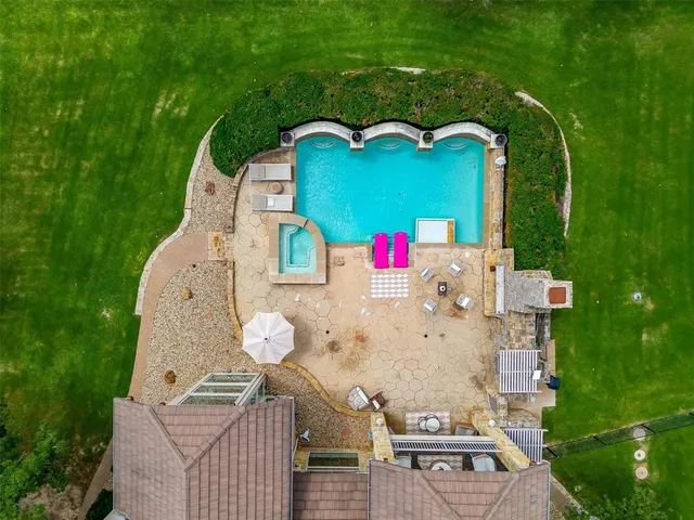 an aerial view of a house with outdoor space pool seating area and yard