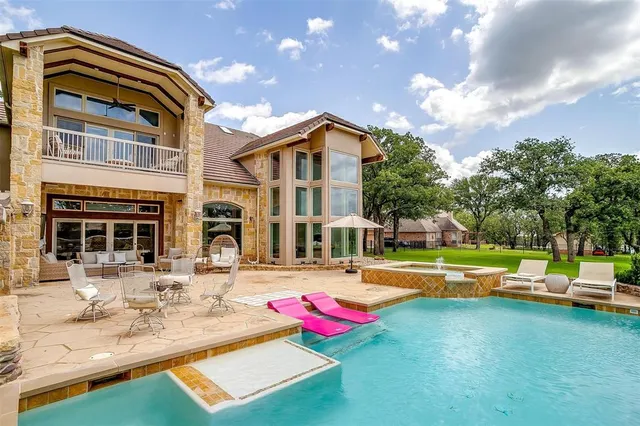 a view of swimming pool with a lounge chairs