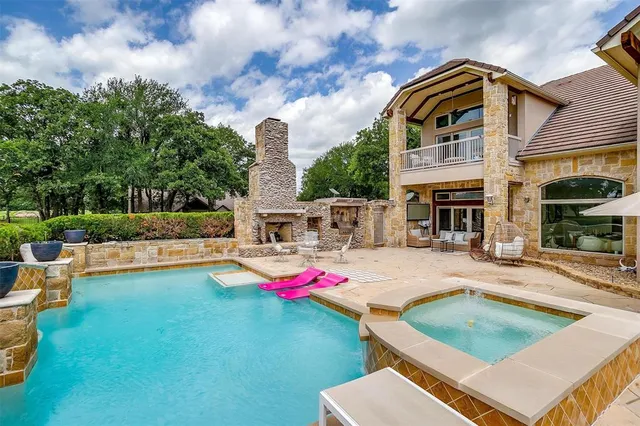 a view of a house with swimming pool and sitting area
