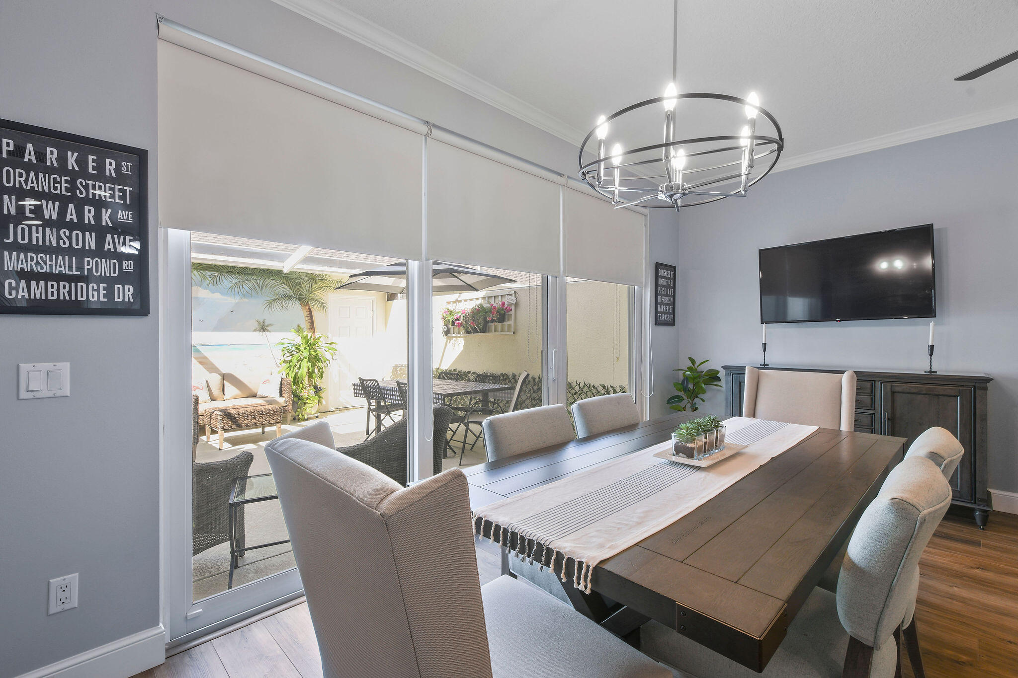 111 Ashley Court Jupiter, FL 33458 - Photo 19 of 68 a view of a dining room with furniture a chandelier and wooden floor