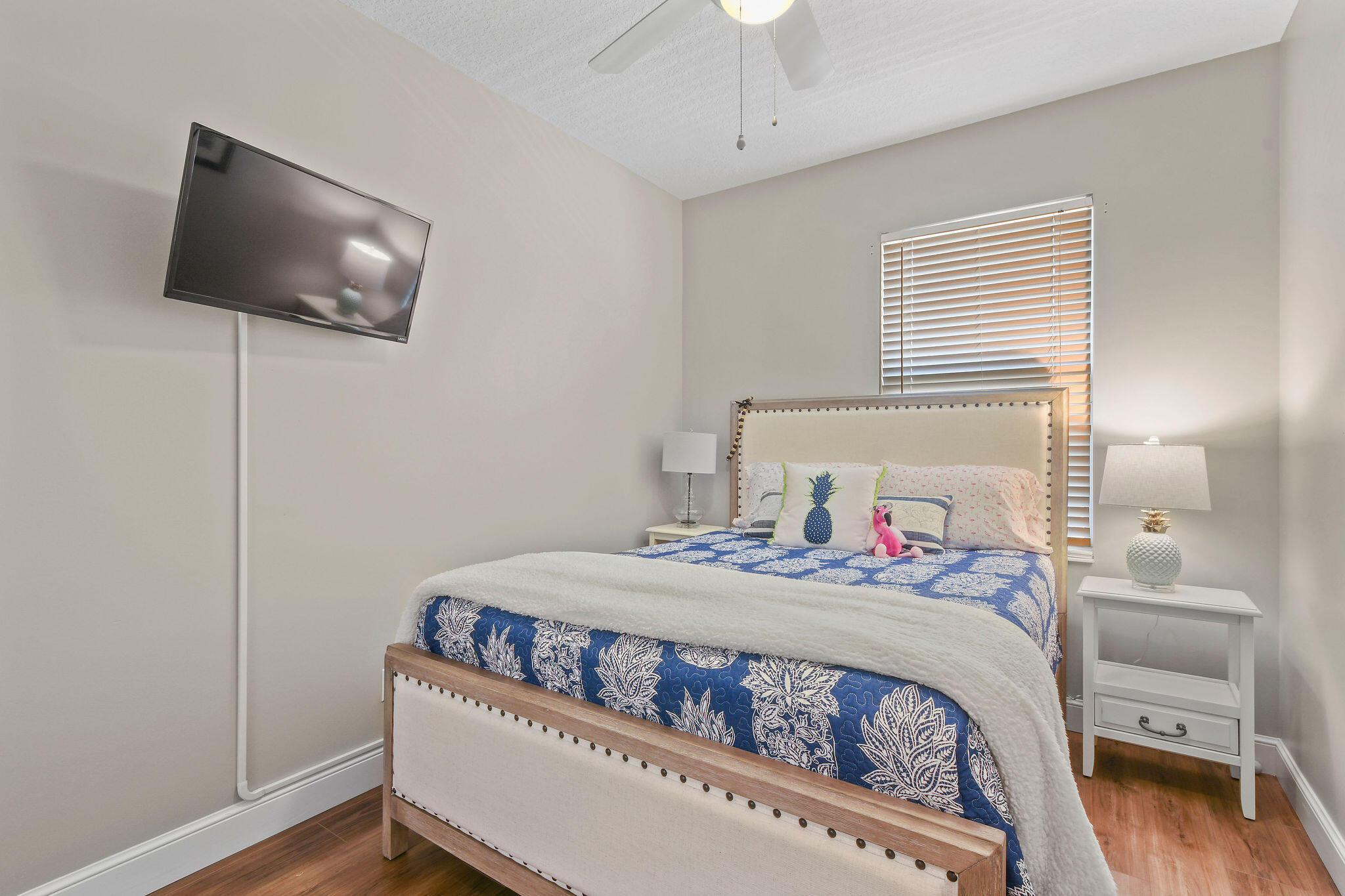 111 Ashley Court Jupiter, FL 33458 - Photo 34 of 68 a bedroom with a bed and a flat screen tv