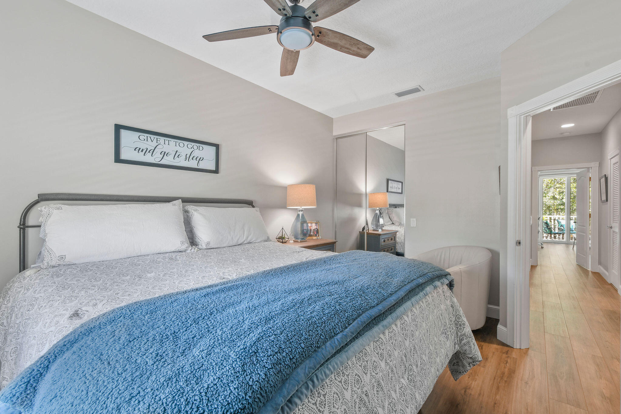 111 Ashley Court Jupiter, FL 33458 - Photo 38 of 68 a spacious bedroom with a bed and a chandelier