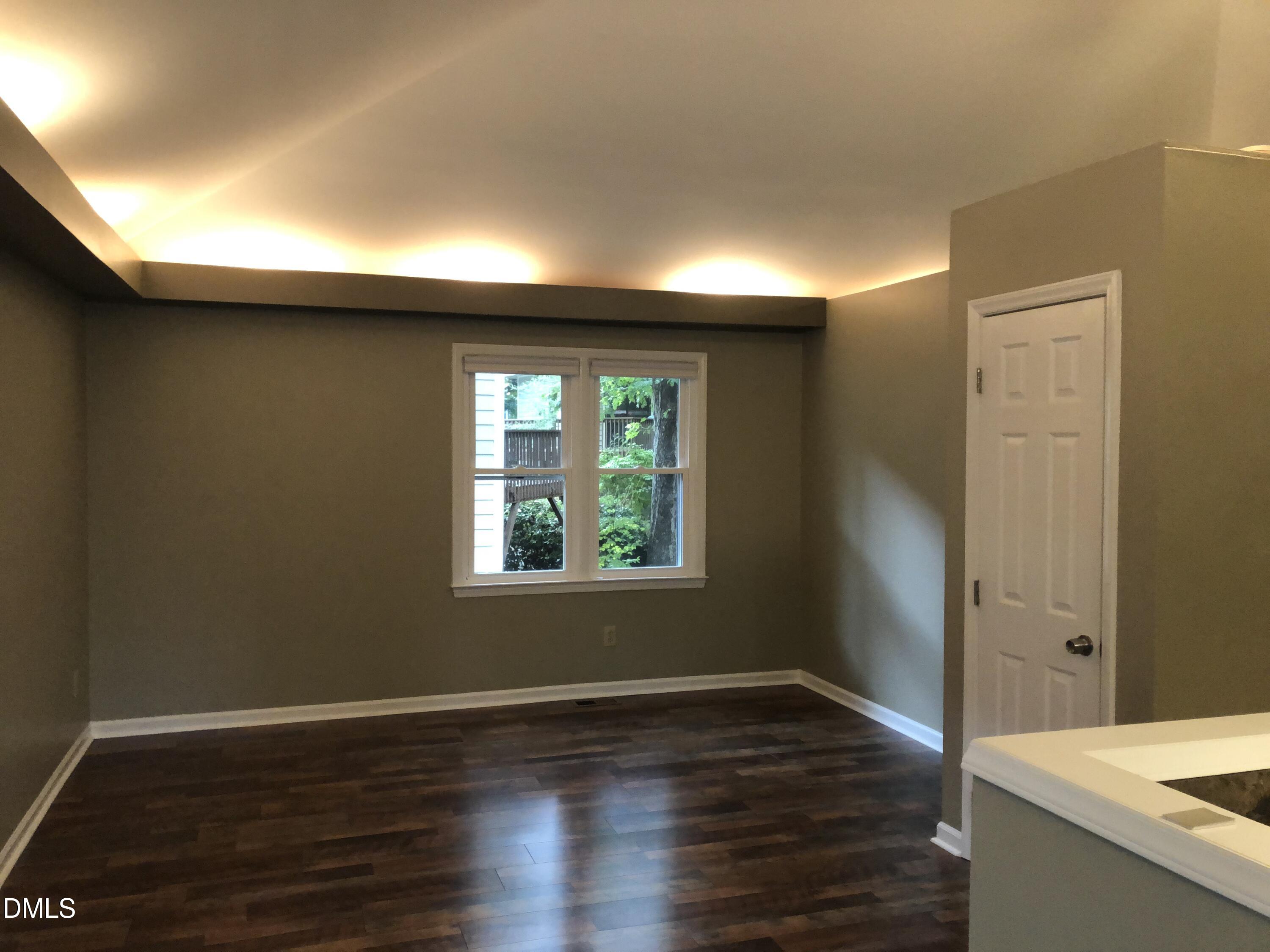 3345 Mill Run Raleigh, NC 27612 - Photo 2 of 11 a view of a livingroom with wooden floor and a window