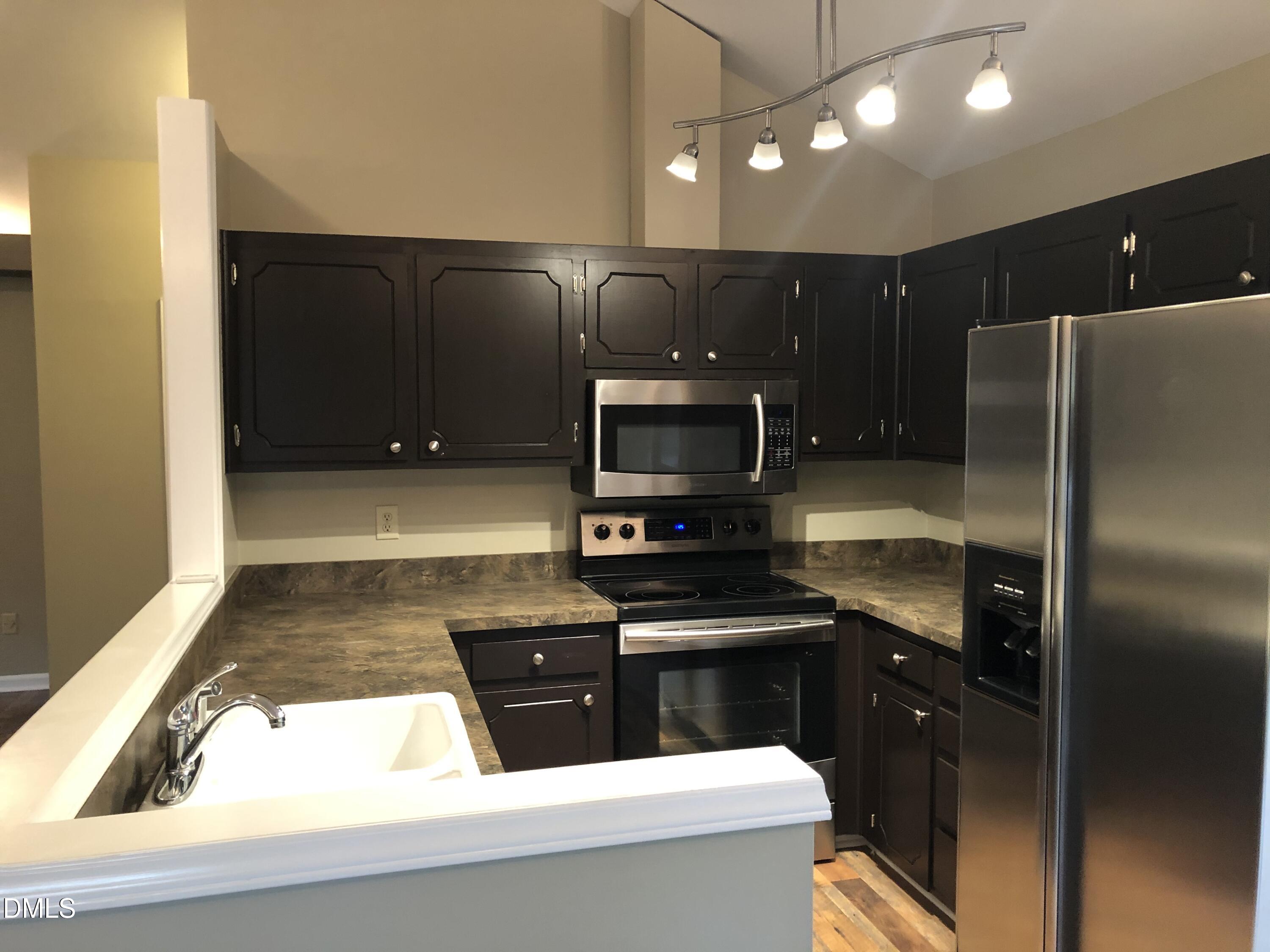 3345 Mill Run Raleigh, NC 27612 - Photo 3 of 11 a kitchen with stainless steel appliances granite countertop a refrigerator and a stove