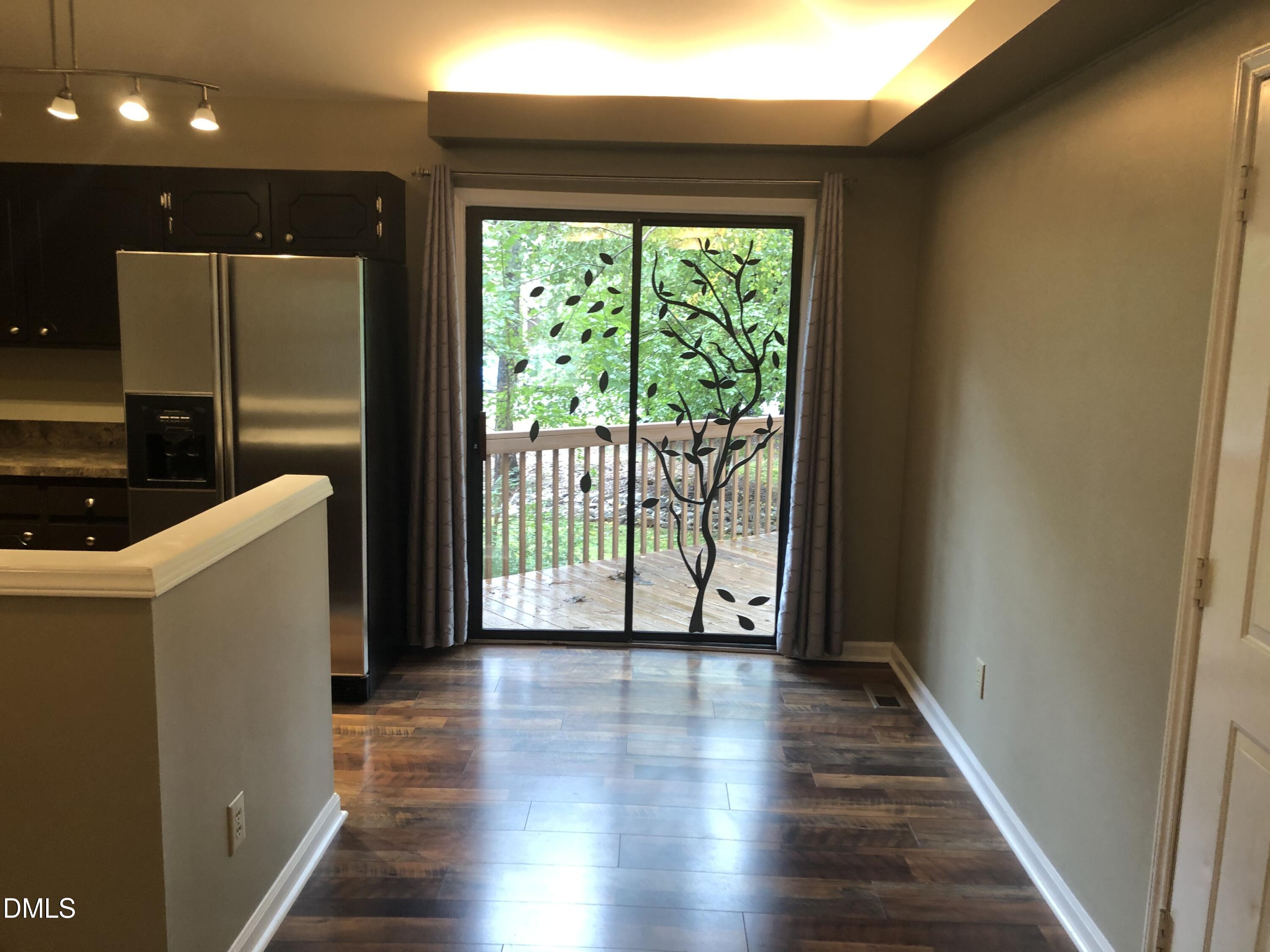 3345 Mill Run Raleigh, NC 27612 - Photo 5 of 11 a view of a hallway with wooden floor and staircase