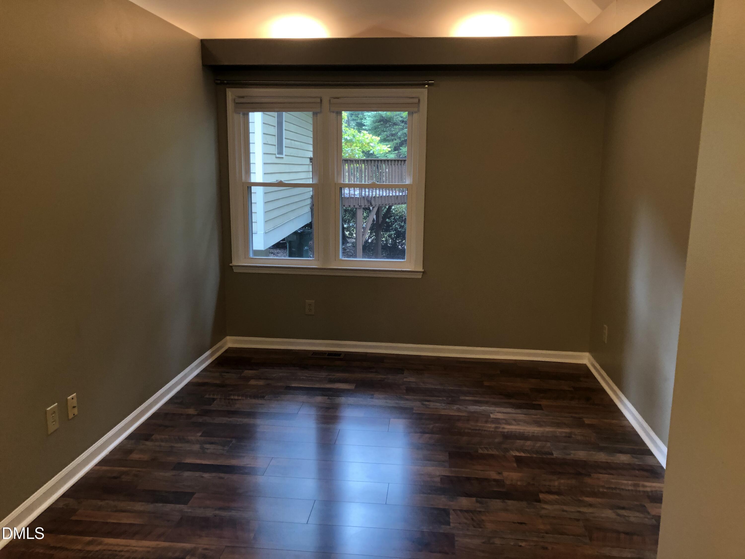 3345 Mill Run Raleigh, NC 27612 - Photo 6 of 11 a view of an empty room with wooden floor and a window