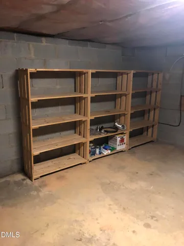 a view of an empty room with a furniture