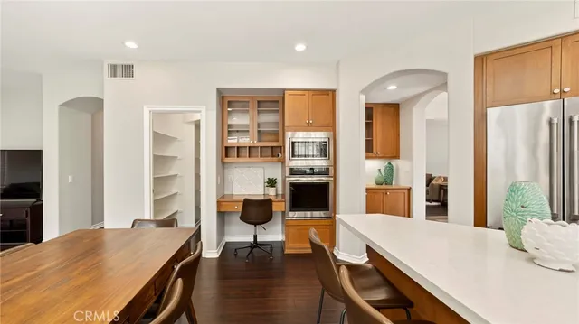 a bedroom with a large bed chandelier and a window