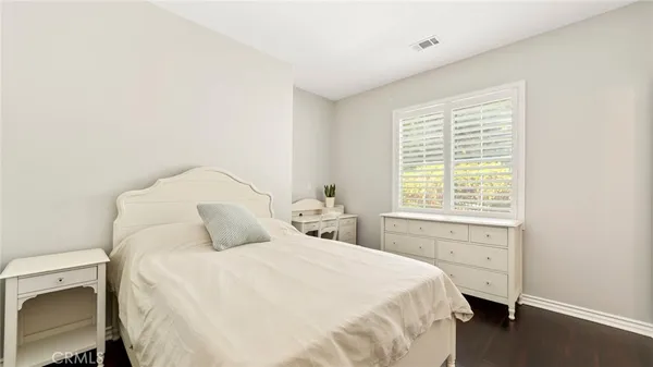 a spacious bedroom with a bed and a chandelier