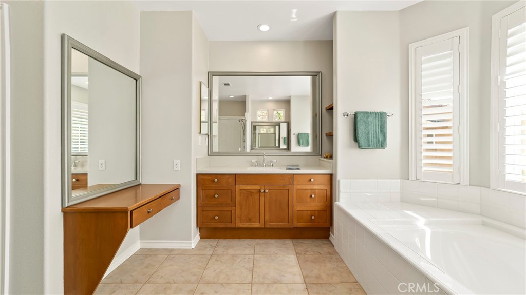 637 Chaparral Court Altadena, CA 91001 - Photo 32 of 58 a bathroom with a granite countertop tub sink and mirror