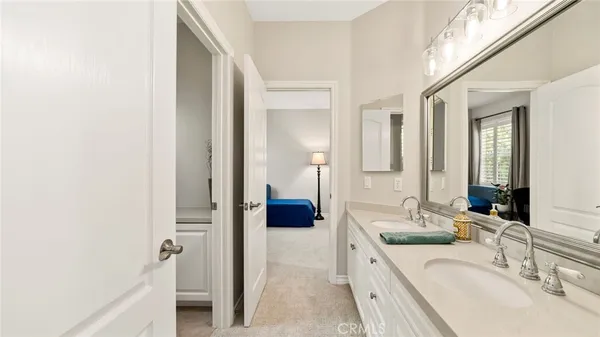 a bathroom with a sink toilet and mirror