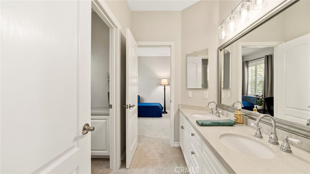 637 Chaparral Court Altadena, CA 91001 - Photo 38 of 58 a en suite bathroom with a double vanity sink and a mirror