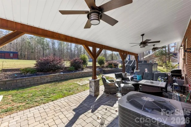 a living room with patio furniture and a rug