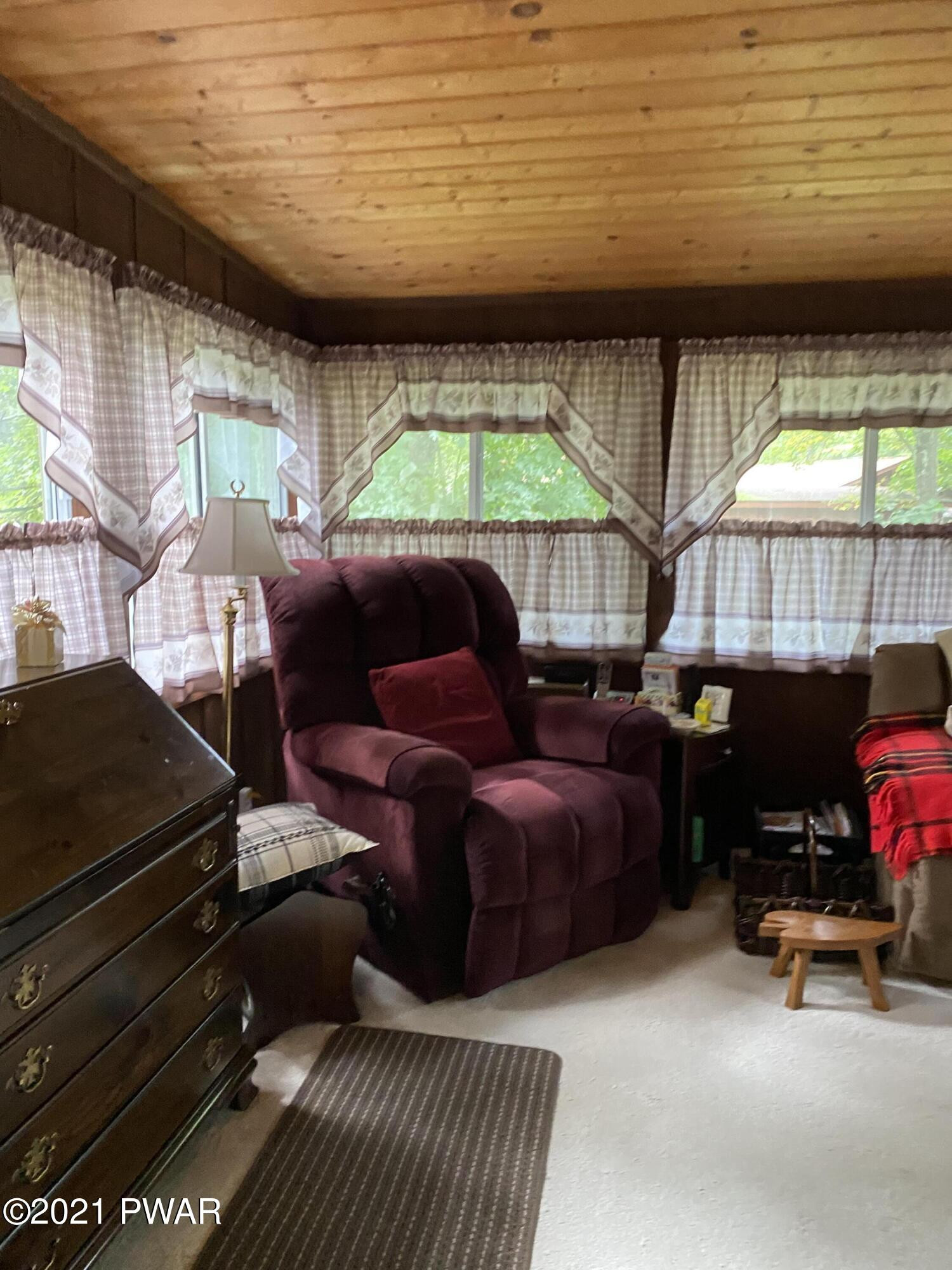 125 Maple Ridge Drive Hawley, PA 18428 - Photo 13 of 49 a outdoor living space with furniture and a fireplace
