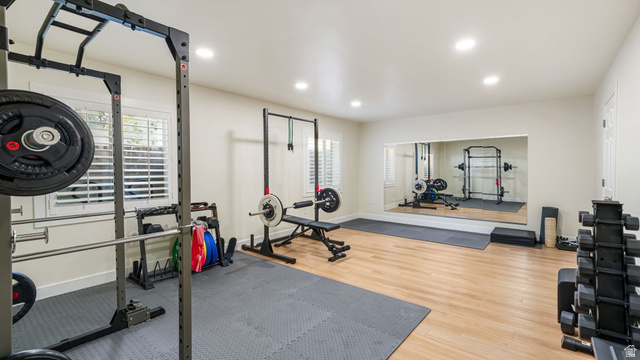 11128 South Barrett Pk Circle Sandy, UT 84092 - Photo 26 of 36 Dedicated fitness space featuring wood-finish flooring, recessed lighting, and a large wall-mounted mirror