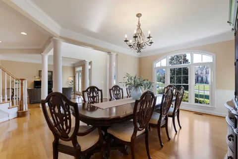 a living room with furniture a wooden floor and a large window