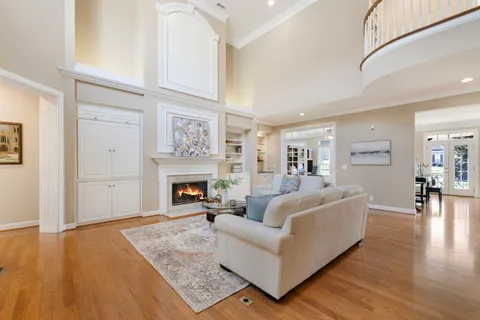a kitchen with stainless steel appliances kitchen island granite countertop a table chairs sink and cabinets