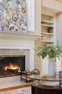 a view of a dining room and livingroom with furniture wooden floor a chandelier
