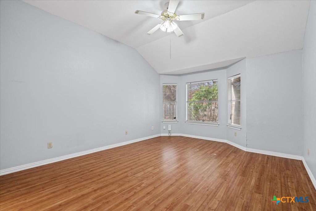 12502 Fallen Tower Lane Austin, TX 78753 - Photo 12 of 28 a view of an empty room with wooden floor and a window