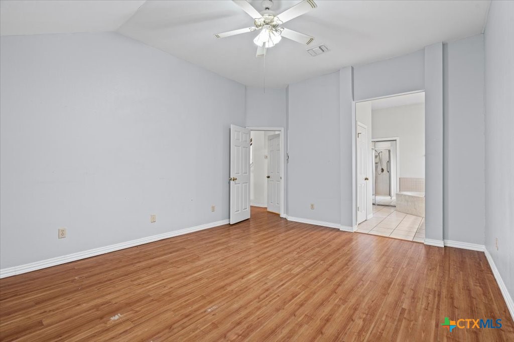 12502 Fallen Tower Lane Austin, TX 78753 - Photo 13 of 28 a view of an empty room with wooden floor
