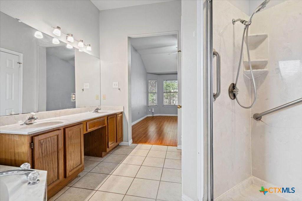 12502 Fallen Tower Lane Austin, TX 78753 - Photo 15 of 28 a bathroom with a sink a vanity and a mirror