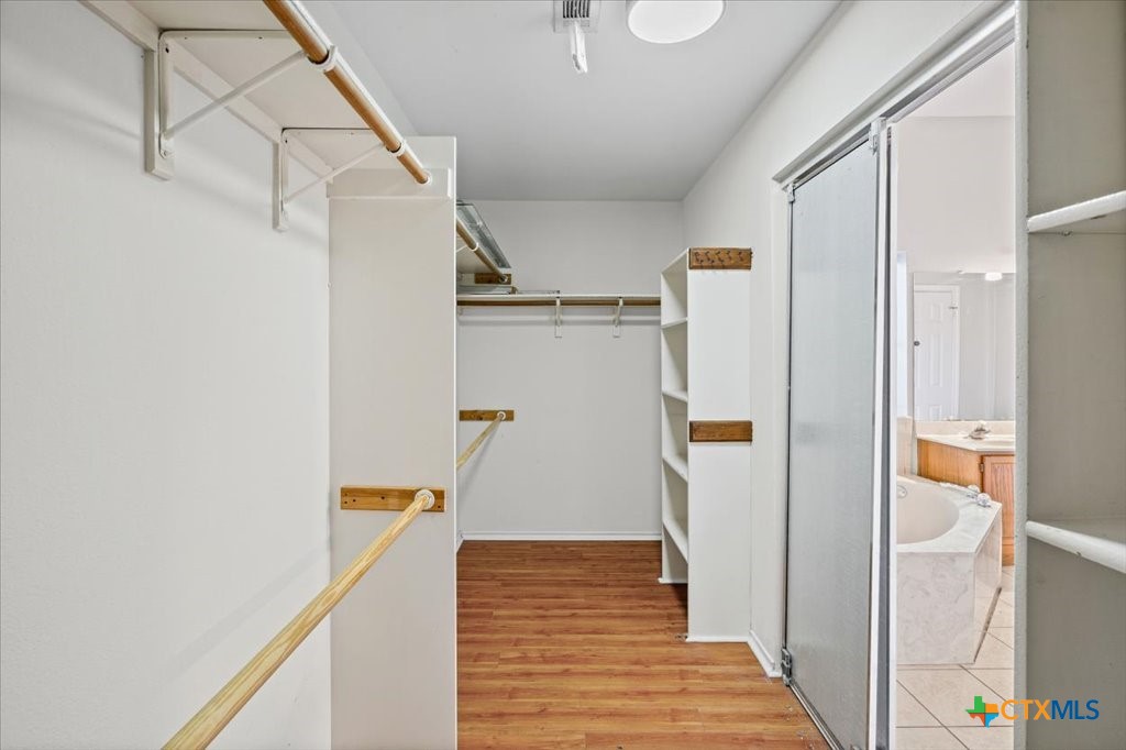 12502 Fallen Tower Lane Austin, TX 78753 - Photo 16 of 28 a view of a hallway with wooden floor and staircase