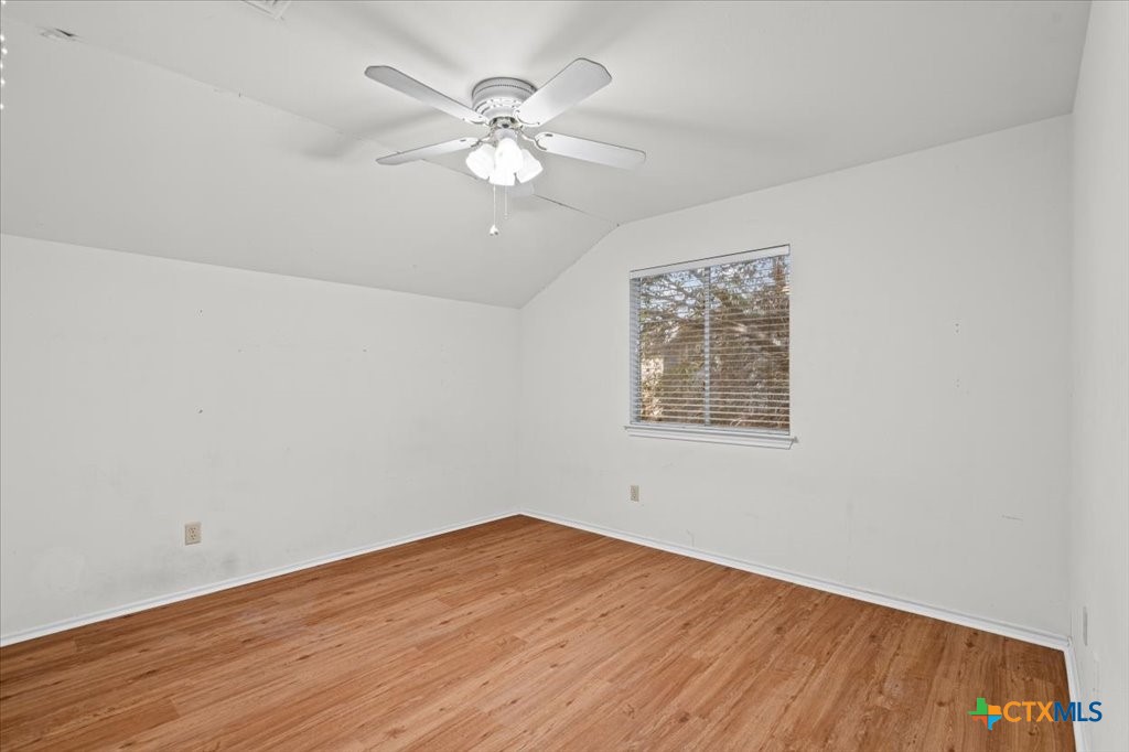 12502 Fallen Tower Lane Austin, TX 78753 - Photo 19 of 28 wooden floor in an empty room with a window