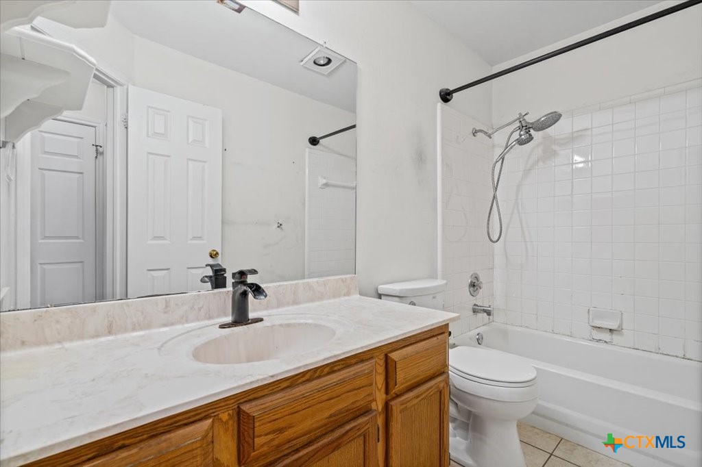 12502 Fallen Tower Lane Austin, TX 78753 - Photo 21 of 28 a bathroom with a granite countertop sink a toilet and a bathtub