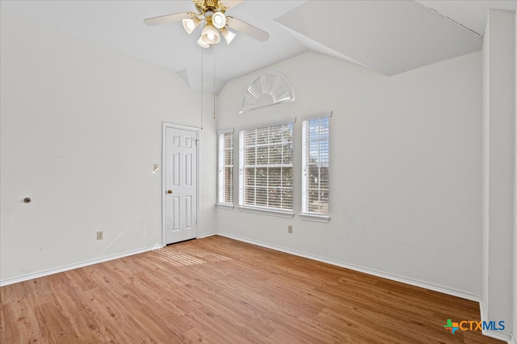 12502 Fallen Tower Lane Austin, TX 78753 - Photo 22 of 28 a view of an empty room with wooden floor and a window