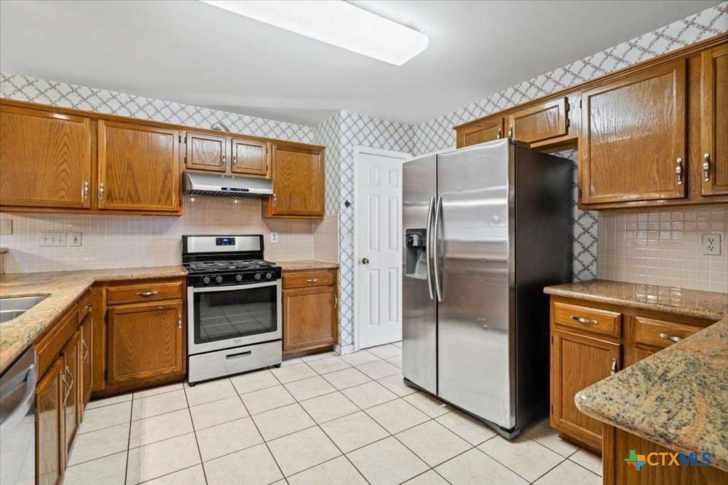 12502 Fallen Tower Lane Austin, TX 78753 - Photo 6 of 28 a kitchen with stainless steel appliances granite countertop a refrigerator stove and sink