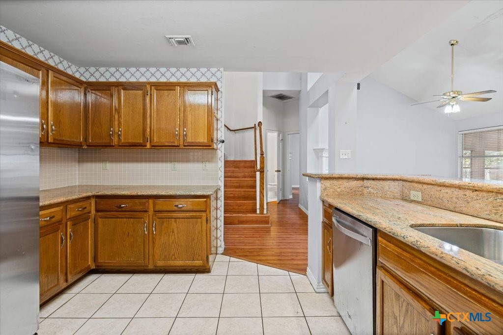 12502 Fallen Tower Lane Austin, TX 78753 - Photo 8 of 28 a kitchen with stainless steel appliances granite countertop a sink and cabinets