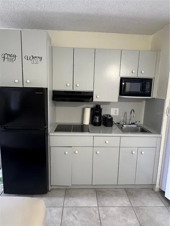 a kitchen with a sink and cabinets