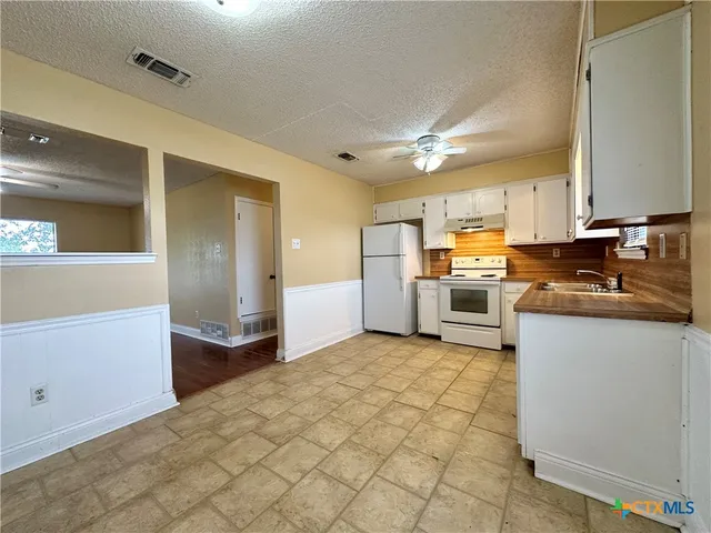 a kitchen with stainless steel appliances cabinets a sink and a stove