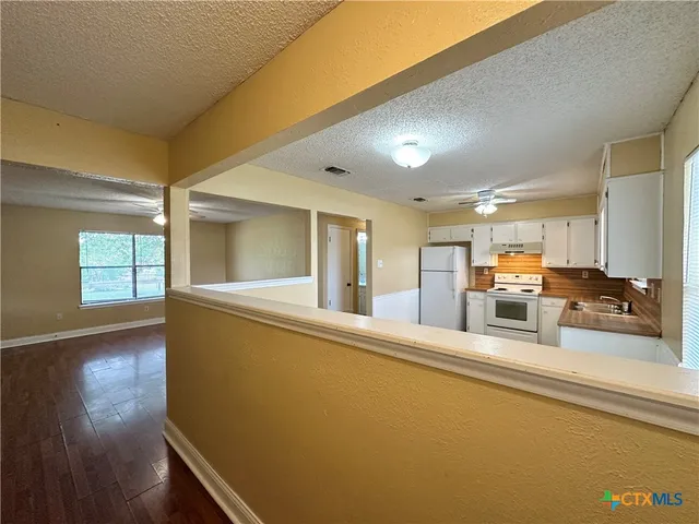 a large room with furniture and wooden floor