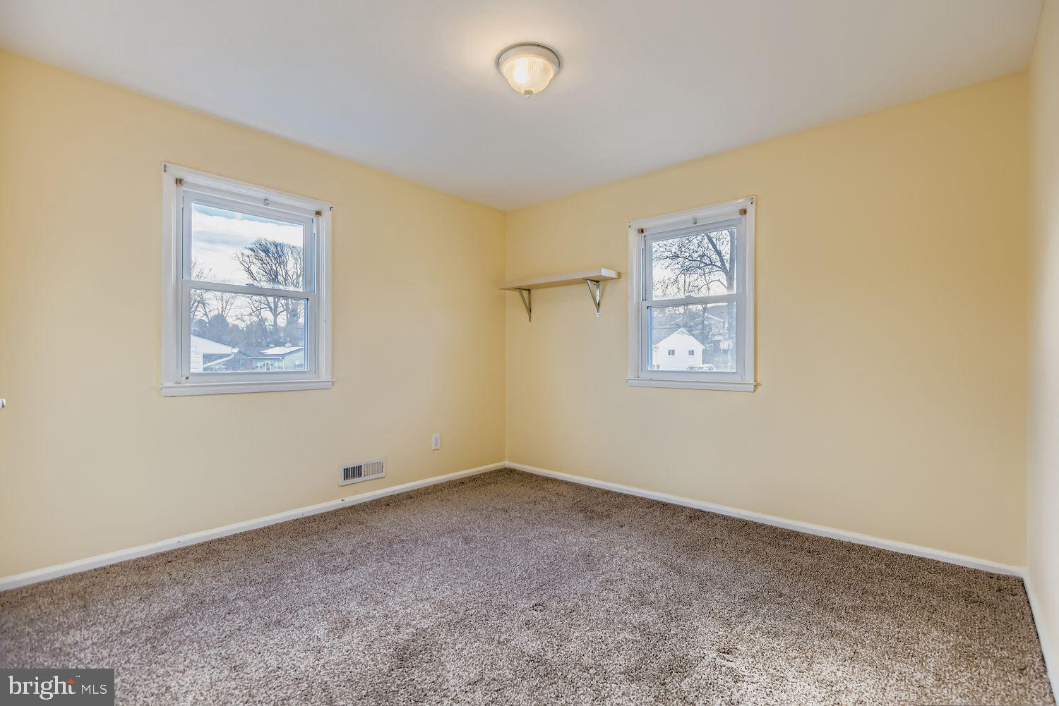 8504 Fieldway Drive Randallstown, MD 21133 - Photo 8 of 20 a view of an empty room with a painting on the wall