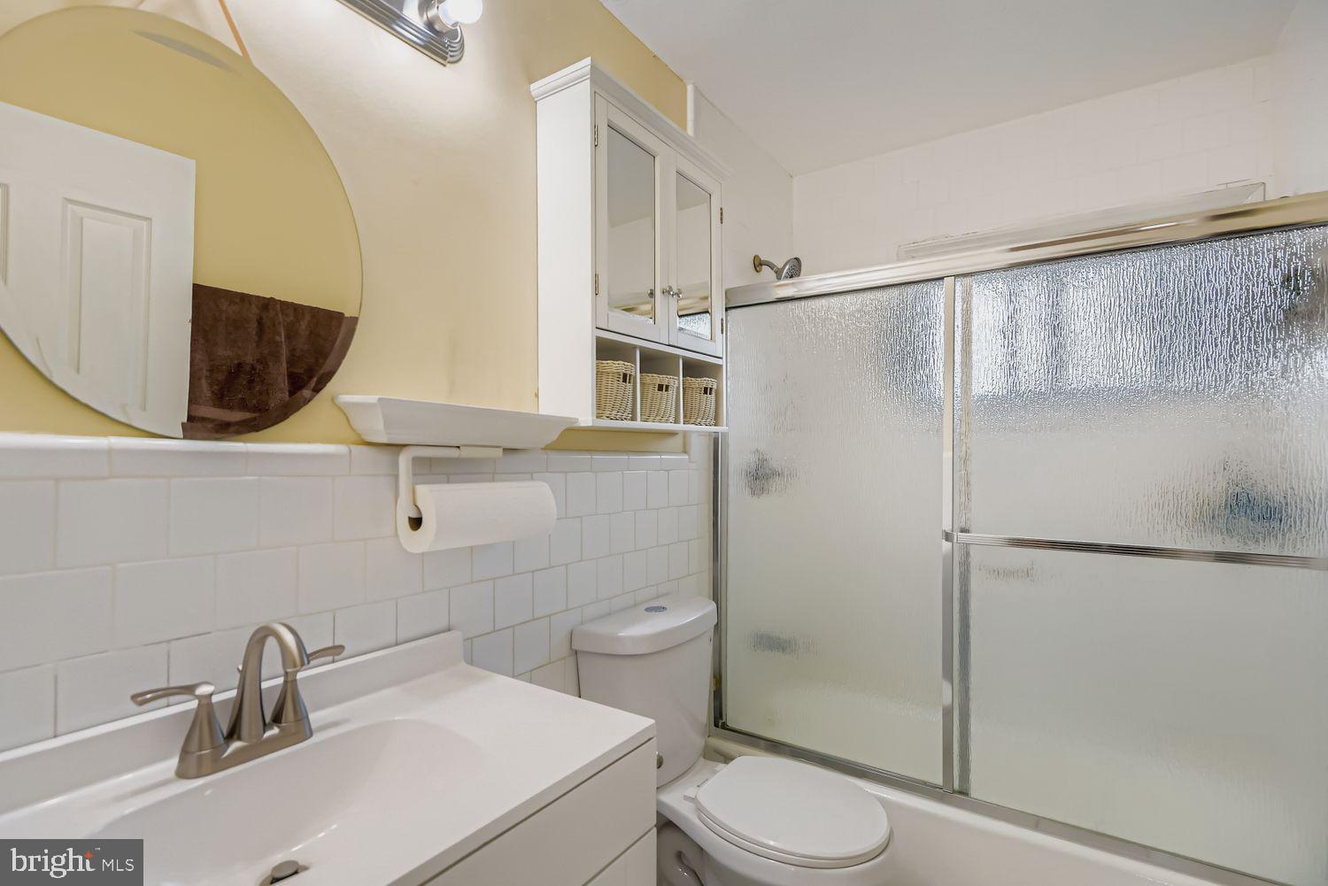 8504 Fieldway Drive Randallstown, MD 21133 - Photo 9 of 20 a bathroom with a sink toilet and shower