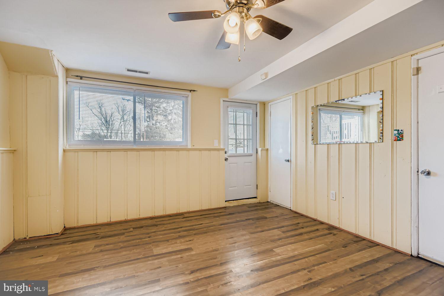 8504 Fieldway Drive Randallstown, MD 21133 - Photo 10 of 20 a view of empty room with wooden floor and fan