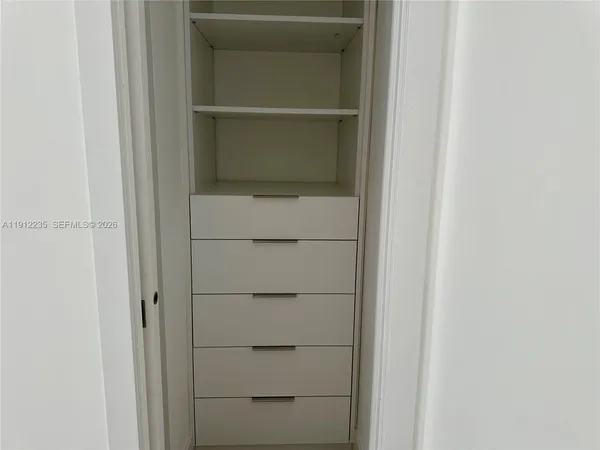 a living room with a couch and a potted plant