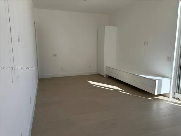 an empty room with hard wood floor