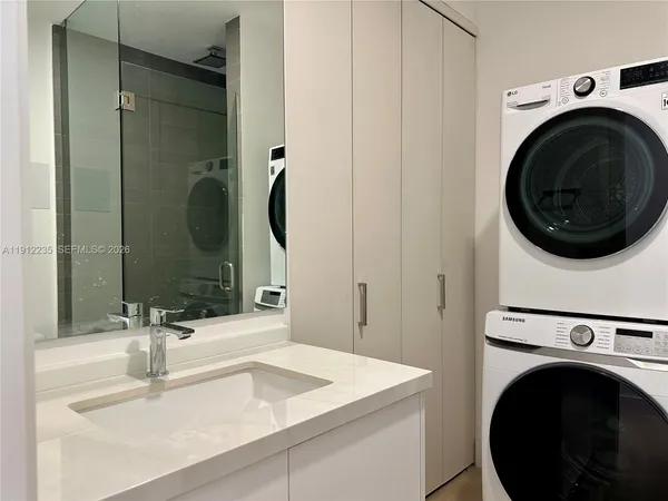 a utility room with sink dryer and washer