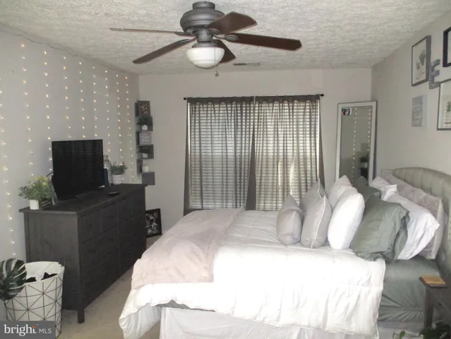 a bedroom with a bed and a television