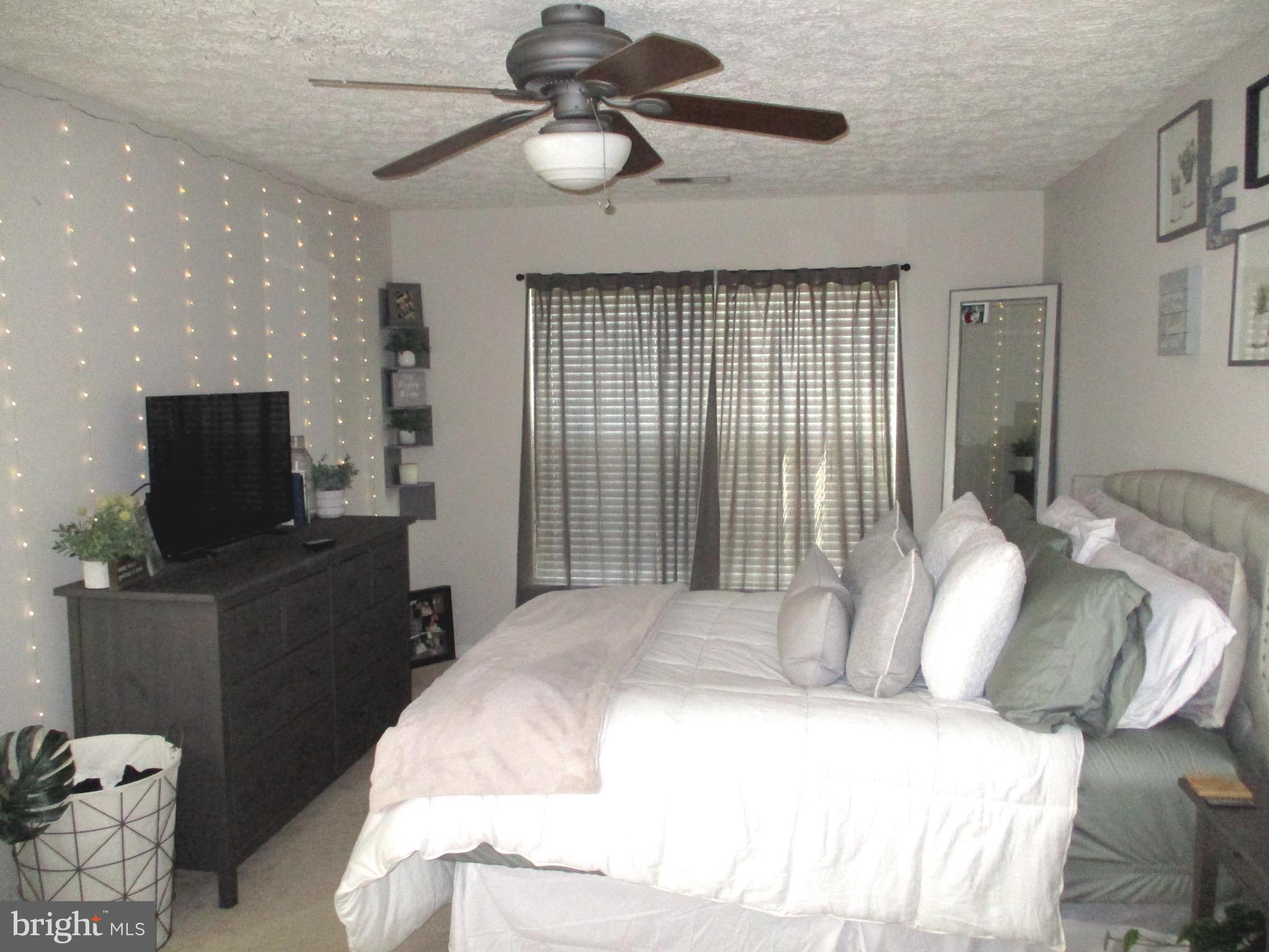 2003 Phillips Terrace, Unit 6 Annapolis, MD 21401 - Photo 5 of 11 a bedroom with a bed and a television