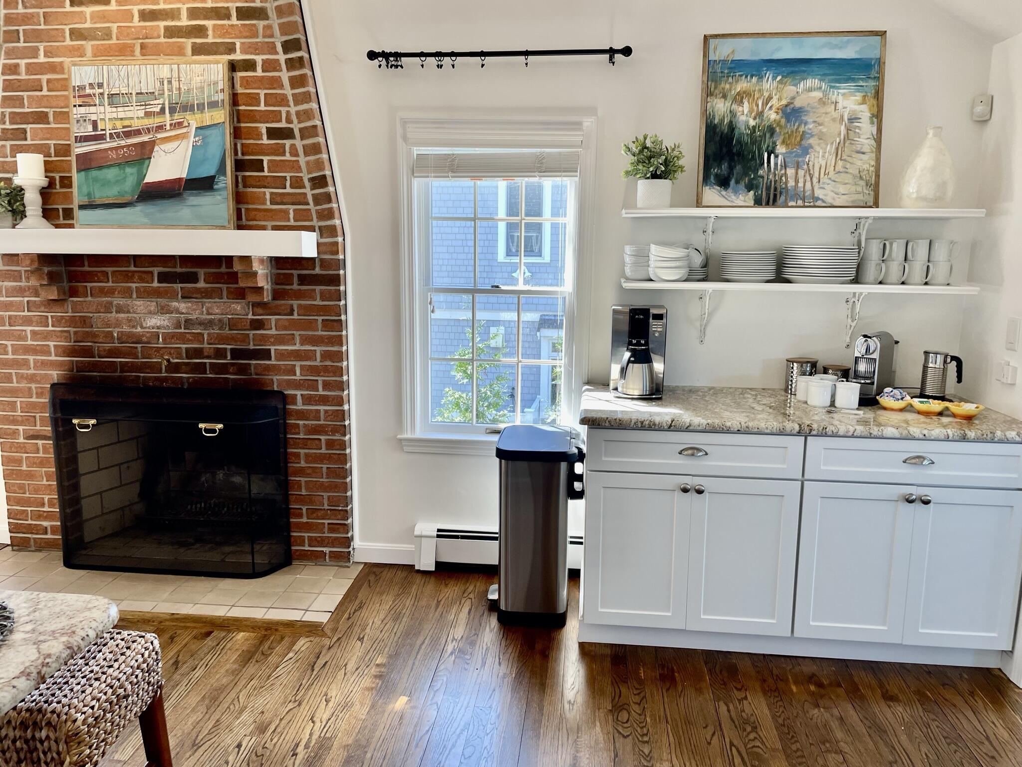 44 Silverleaf Lane Dennis, MA 02638 - Photo 16 of 61 a kitchen with a wooden floor and a fireplace