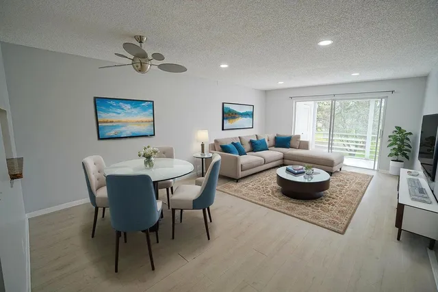 a living room with furniture and a potted plant