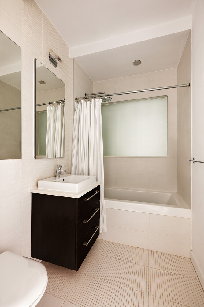 101 North 5th Street, Unit 2AB Brooklyn, NY 11249 - Photo 11 of 13 a bathroom with a sink a toilet and shower