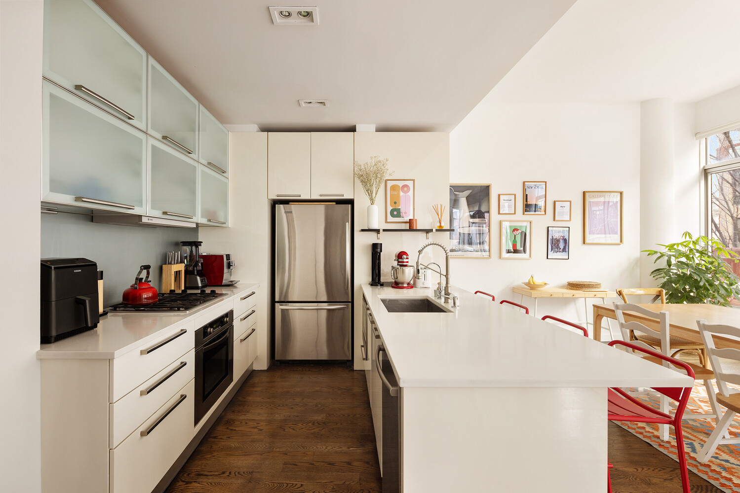 101 North 5th Street, Unit 2AB Brooklyn, NY 11249 - Photo 5 of 13 a kitchen with refrigerator a stove a sink dishwasher and white cabinets with wooden floor