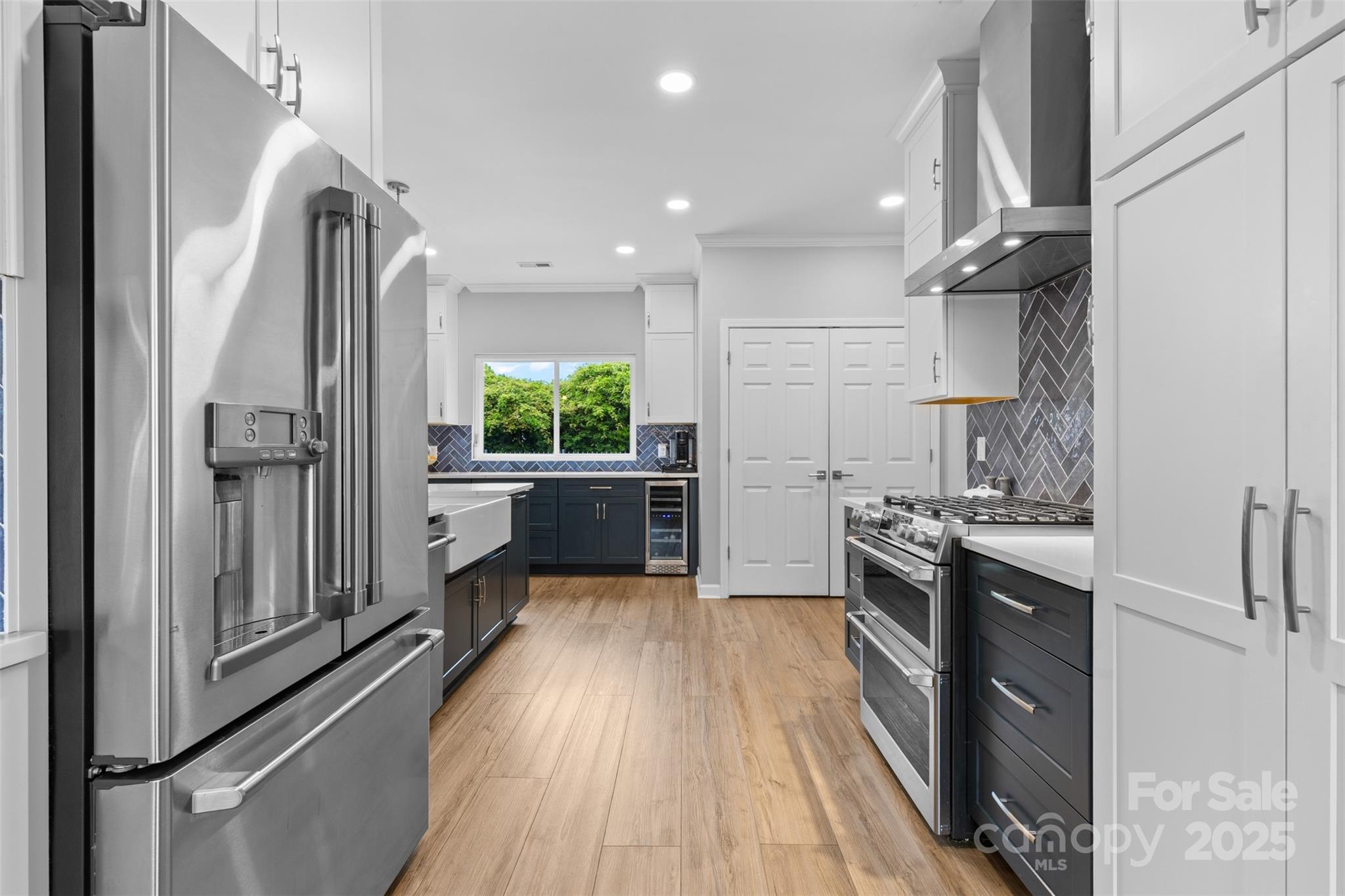 879 Knightsbridge Road Fort Mill, SC 29708 - Photo 12 of 42 a kitchen with kitchen island granite countertop a refrigerator a sink dishwasher a stove and a dining table with wooden floor