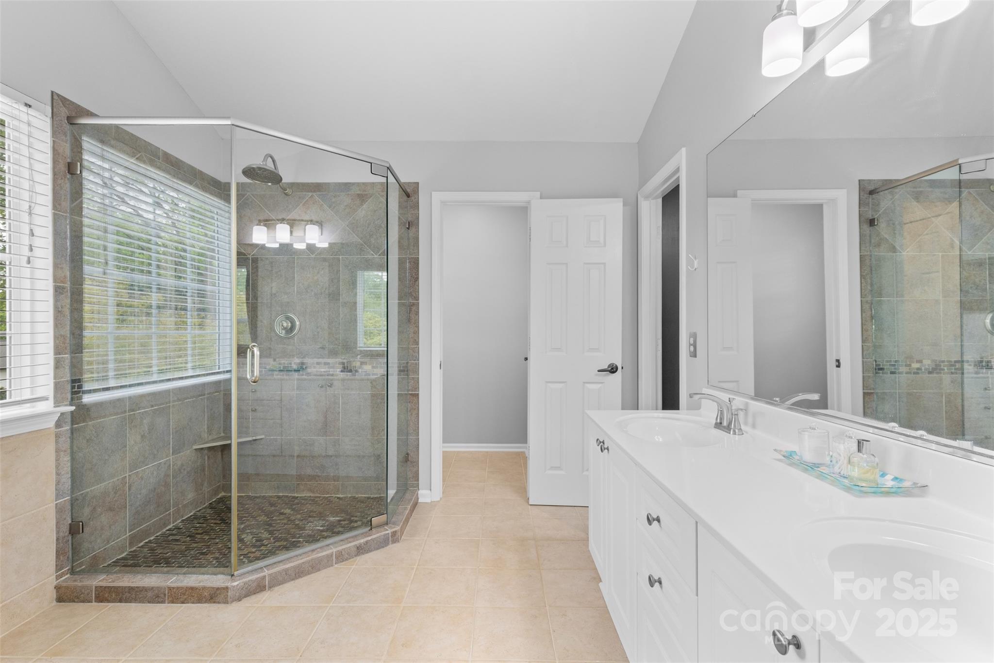 879 Knightsbridge Road Fort Mill, SC 29708 - Photo 26 of 42 a spacious bathroom with a shower sink and mirror