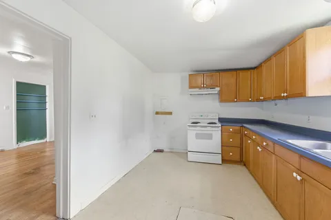 a kitchen with white cabinets and white appliances