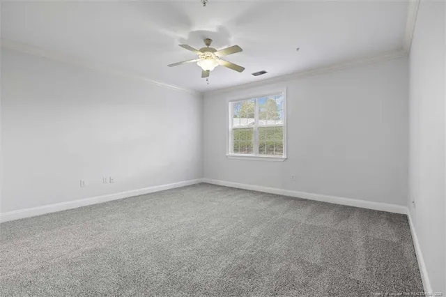 a view of an empty room with a ceiling fan
